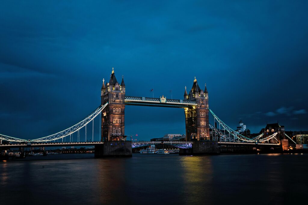 A stunning view of the illuminated Tower Bridge in London against a deep blue night sky.