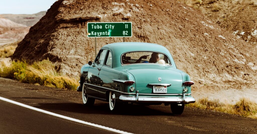 Classic vintage car driving through the scenic desert landscape of Arizona near Tuba City.